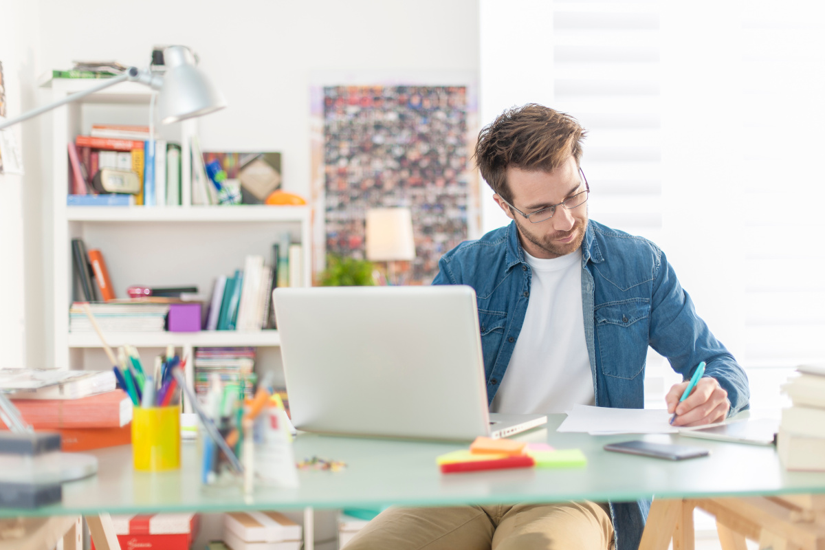 Young Man Working From Home on Laptop Computer