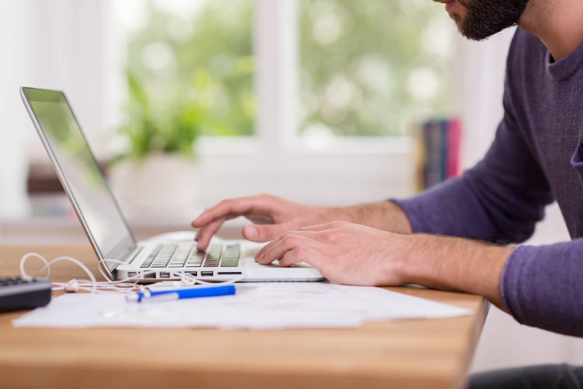 A man working remotely on his laptop