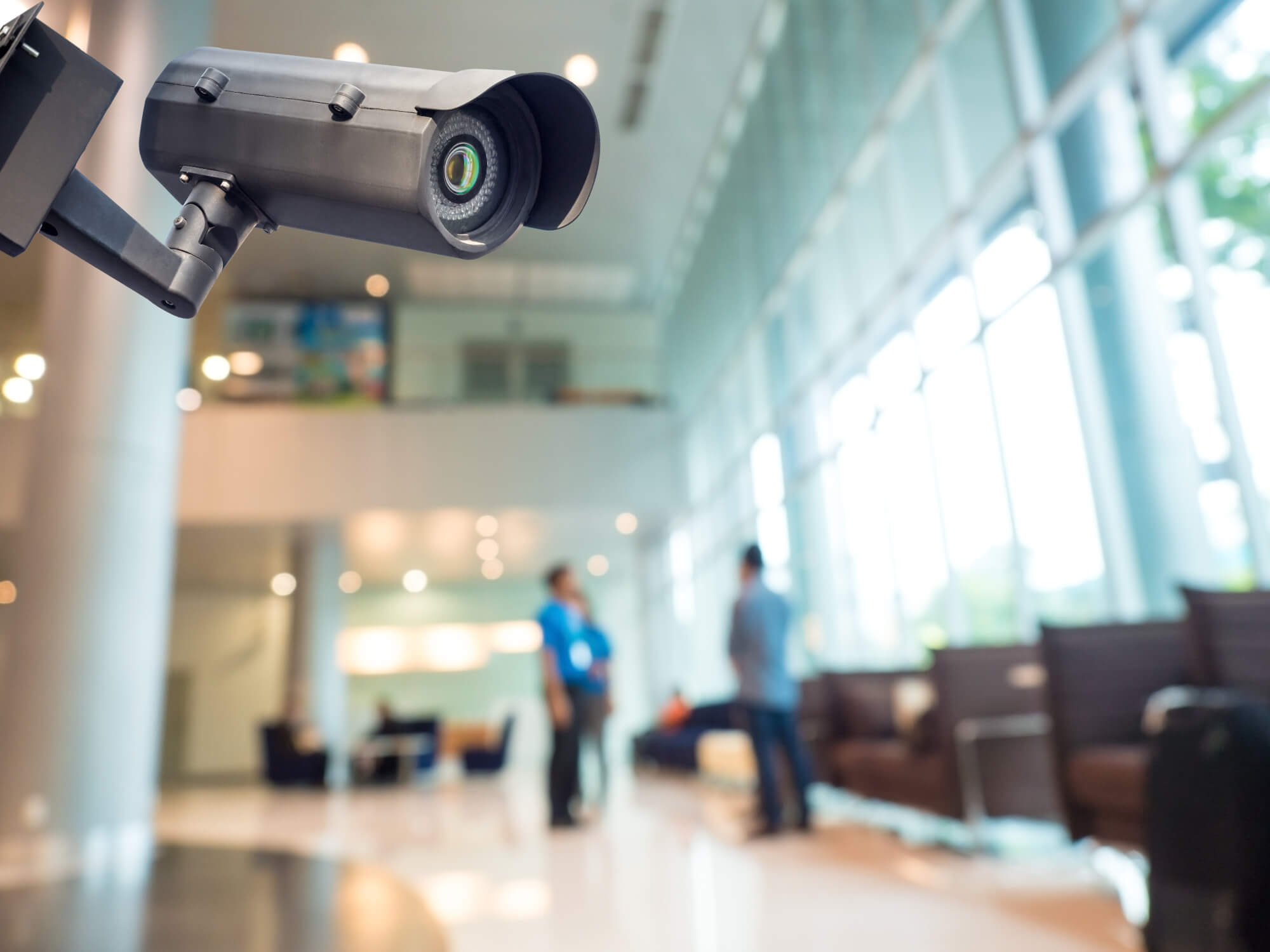 Close up of a security camera mounted on a wall in a lobby