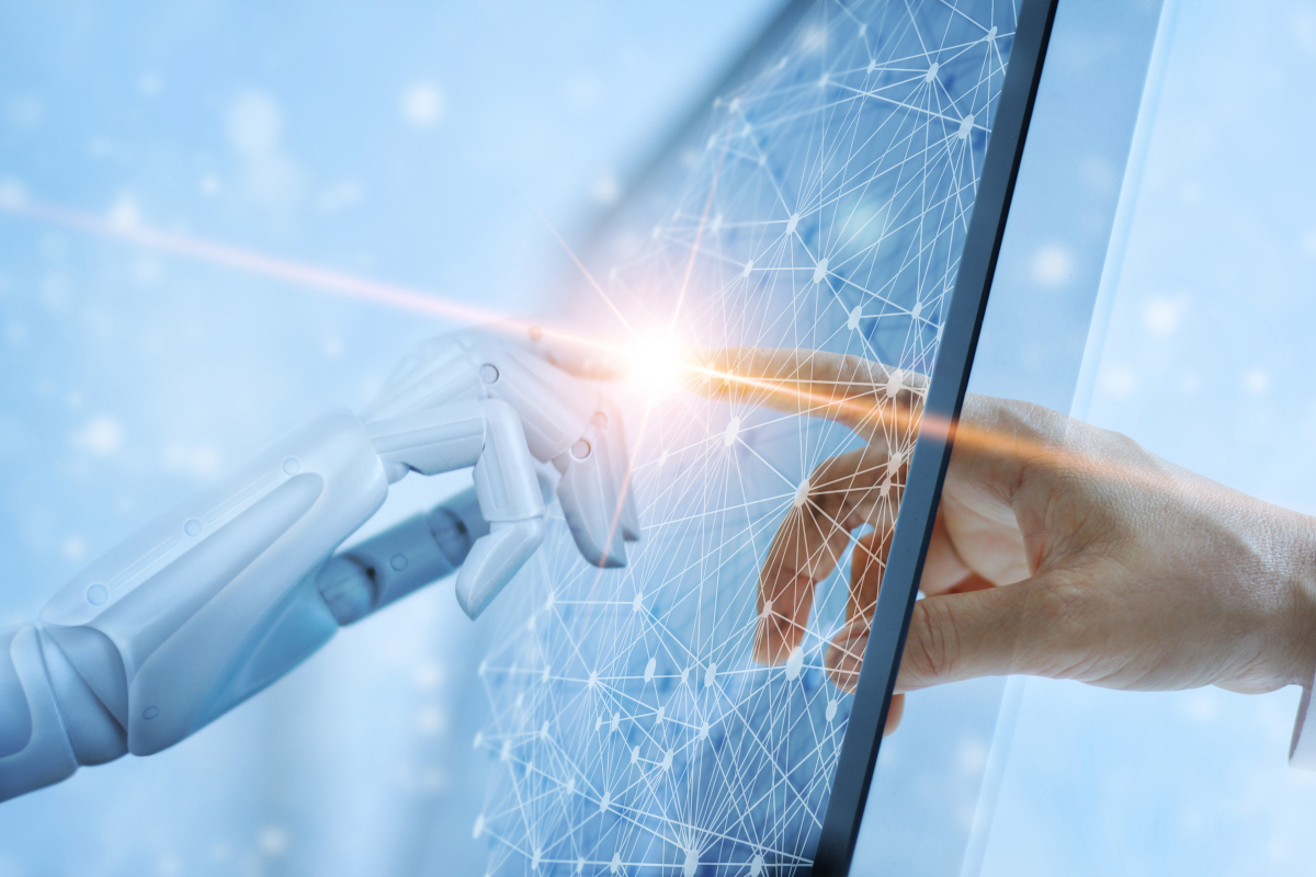 A robot hand and a human hand reaching out to touch a screen from opposite sides