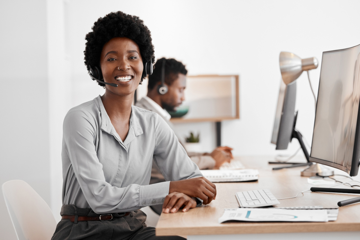 A help desk agent looking towards the camera and smiling