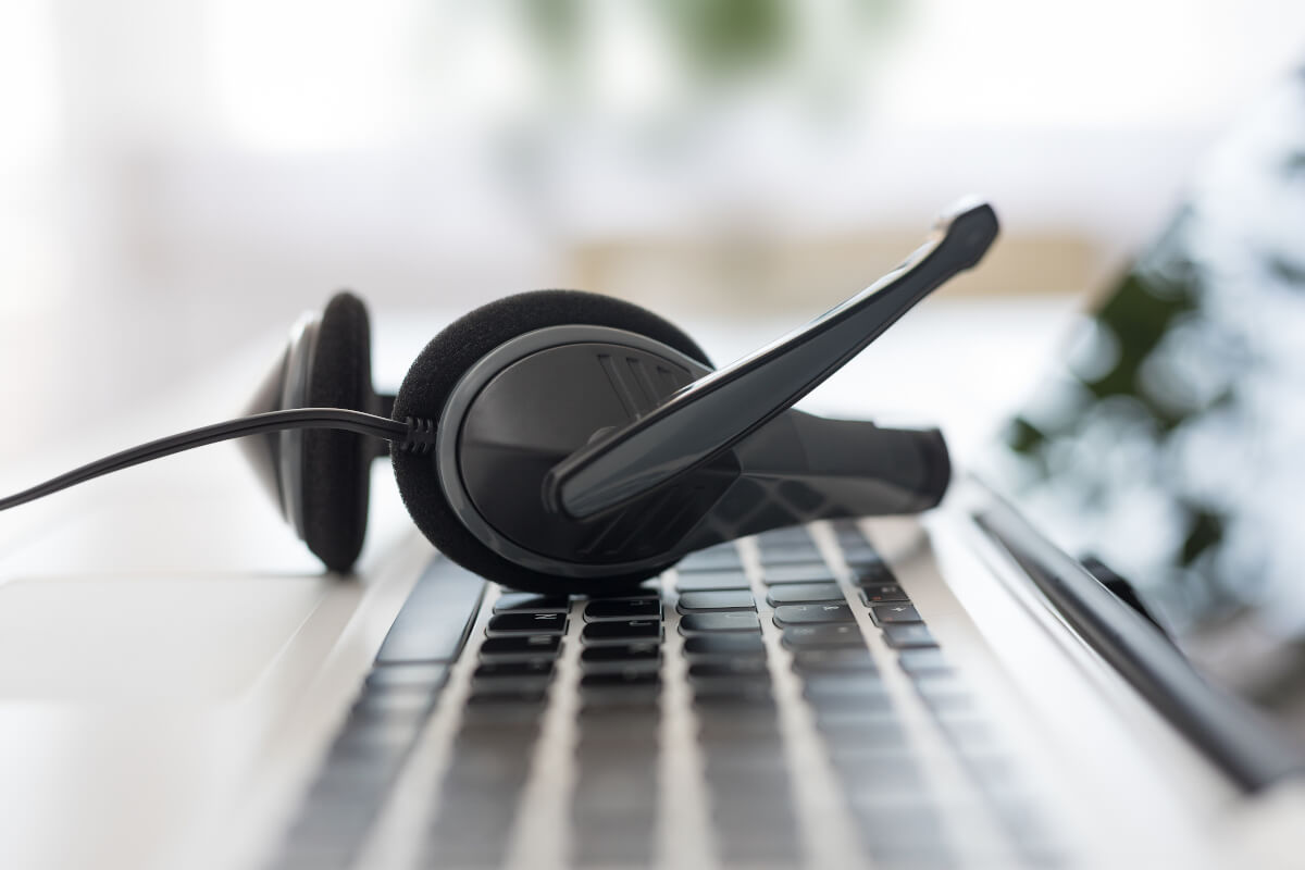 VoIP business phone headset resting on keyboard